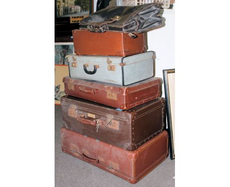 A stack of vintage leather suitcases from the 20th century to include example with White Star Line label. H76 x W102 x D50cm