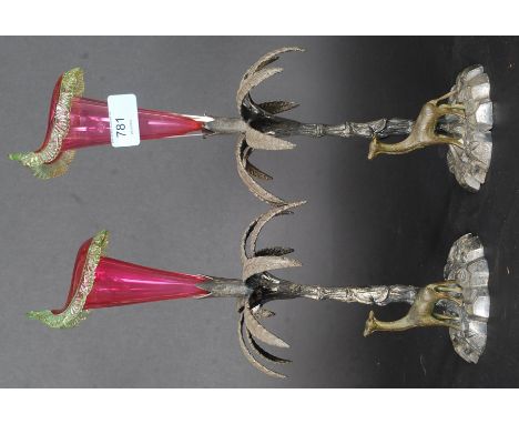 A pair of Victorian electroplate and cranberry glass epergne. The bases in the form of palm trees with deer set on naturalist