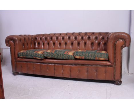 An antique style tan leather button back Chesterfield sofa settee. The barrel arms and back rest being buttoned with tan leat