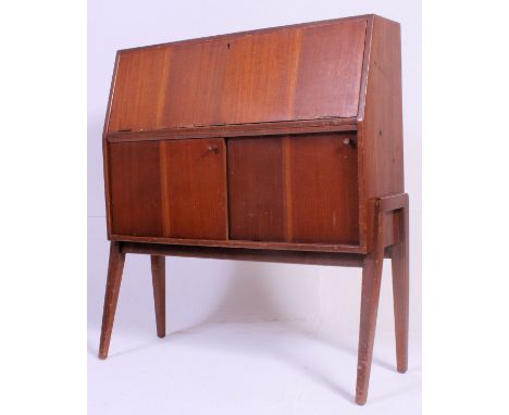 A vintage 1950's retro bureau being raised on angled supports with fall front bureau atop. H12 x W92 D 28 cm 