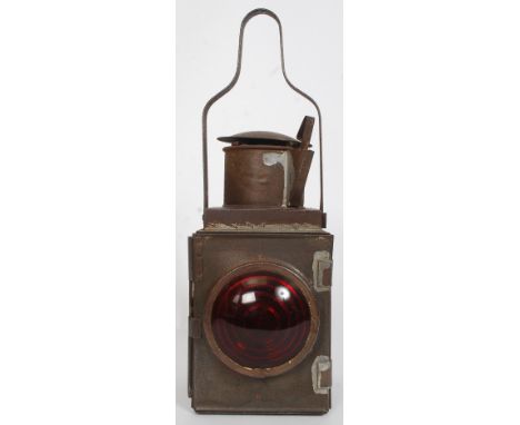 An early 20th century rail guards oil lamp of square form having red lense complete with oil tray