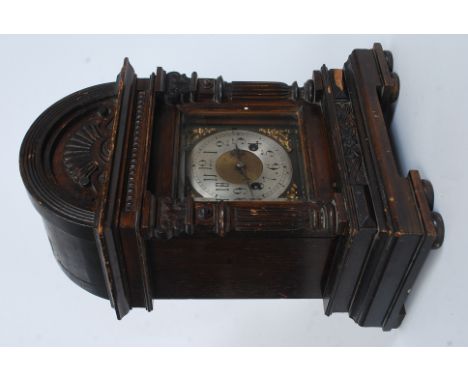 An ebonised oak cased Junghans mantle clock, early 20th Century With a 13cm silvered dial with Arabic numerals, flower and le