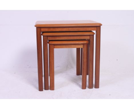 A vintage retro Danish style teak wood 1970's nest of 3 tables with graduating tops.