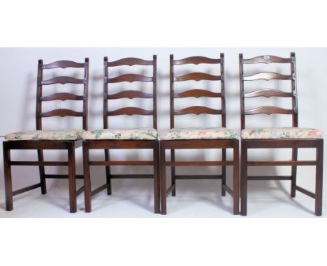 A set of 4 Ercol dark wood ladderback dining chairs being raised on squared legs united by stretchers having slatted panel se