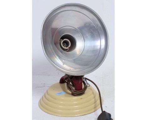 A retro vintage heat lamp having metal painted shade raised on an adjustable cast metal stand. H40 x  W27 cm 
