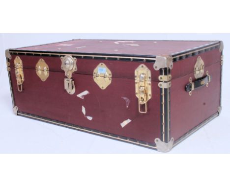 A vintage early 20th century steamer trunk having central clasps with banded exterior