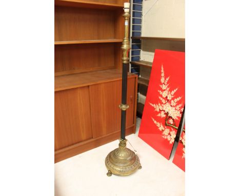 An Edwardian brass adjustable telescopic standard lamp, standing on small bun brass feet, with ribbed central column