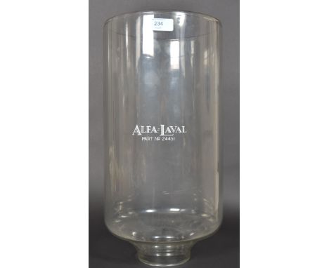 A vintage large glass Alfa Laval Industrial dairy milking measures jar