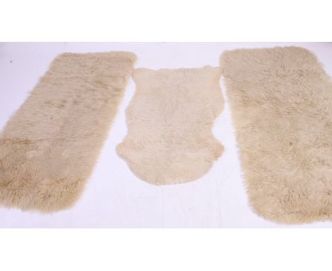 A group of vintage 20th century Sheepskin hide rugs some with labels attached to the verso. H155 x w79 cm 