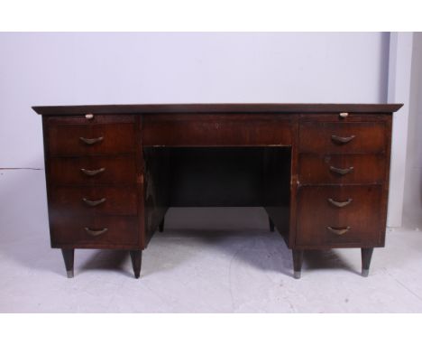 A vintage twin pedestal oak office desk with drawers to the pedestal. The desk by Sellex