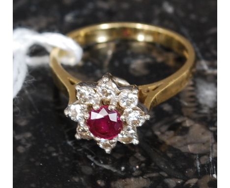 An 18ct yellow gold ruby and diamond ring. The central ruby with surrounding diamonds. Total weight 4.2g