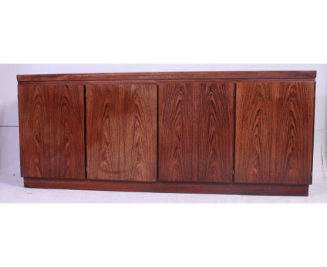 A vintage Danish Rosewood sideboard by Skovby with central double cupboard having a right hand single cupboard and left hand 