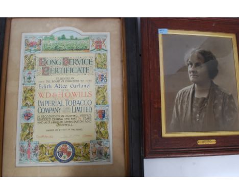 A framed and glazed certificate presented to E.A Garland from W.O Wills factory for long service along with a framed and glaz