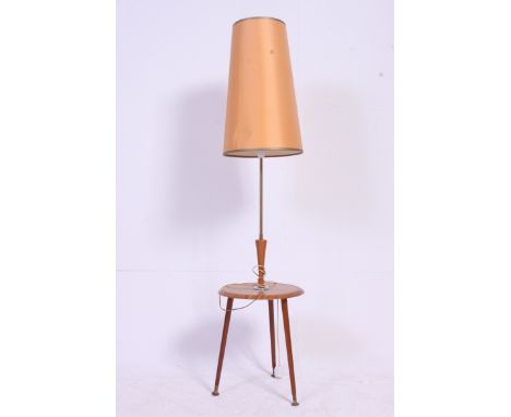 A vintage 1950's standard lamp table. The base on tapered legs with circular tier having upright stem and shade. H140 x W34 c