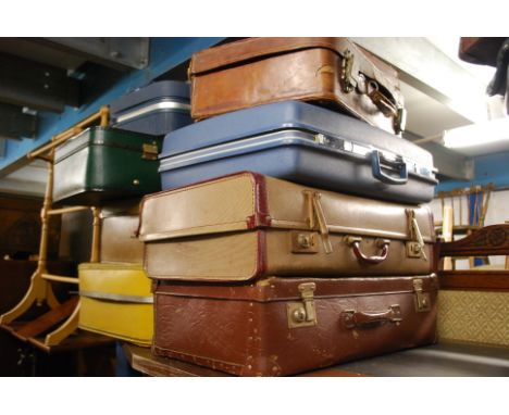 A stack of vintage suit cases to include different varieties to include American  etc
