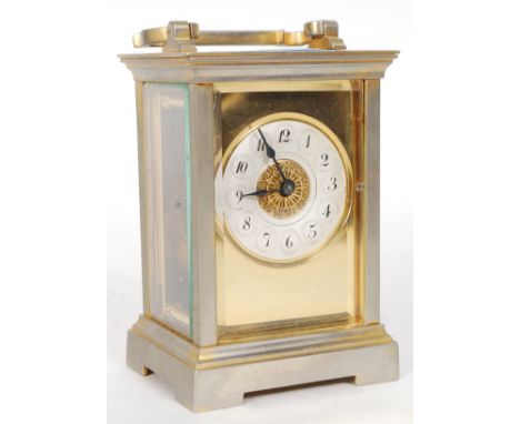 A brass cased French carriage clock, with viewing panels to all sides, brass movement and stamped ' Made In France ' to rear