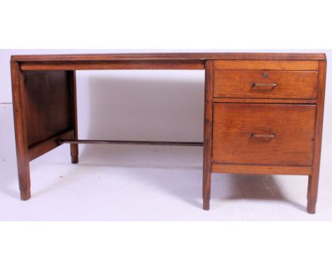 A large vintage 1930's oak twin pedestal desk  with orange original writing surface having pedestal drawers with metal bar su