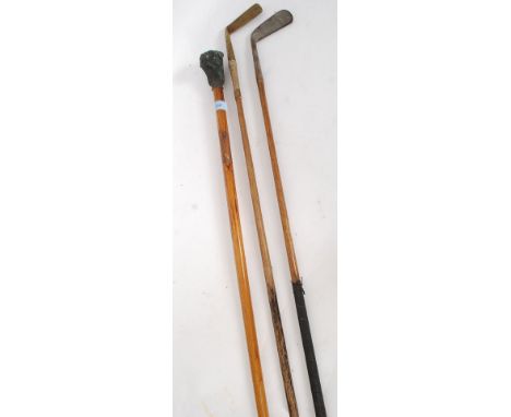 A good early 20th century zoomorphic walking stick cane with handle in the form of a dog, along with two antique golf clubs