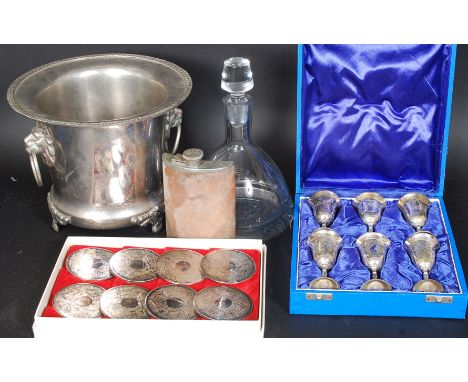 A collection of drinking related items to include a set of silver plated coasters, a wine cooler, hip flask, decanter and a s