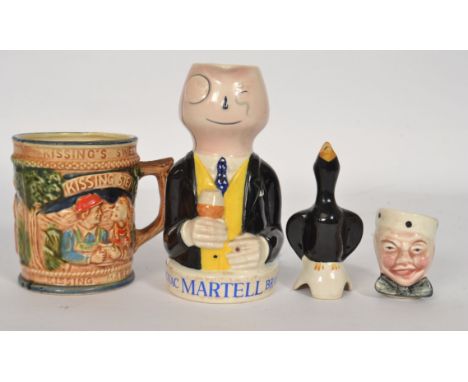 A 1950`s Cognac Martell Brandy advertising jug modelled as a yellow waistcoated man wearing a monocle and holding a cigar, pr