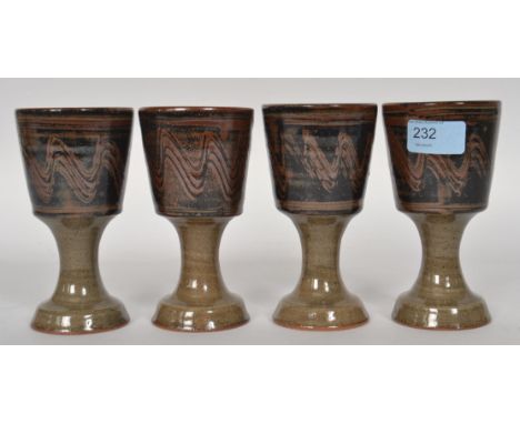 Ray Finch ( British, 1914-2012 ) A set of four studio pottery wine goblets with simple glaze. Winchcombe Pottery. H15 cm 