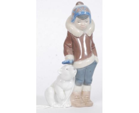 A Lladro figurine ' Eskimo Boy with Pet ' Bearing impressed model  No 5238 with blue stamp to base. Measures 14.5cms High - C