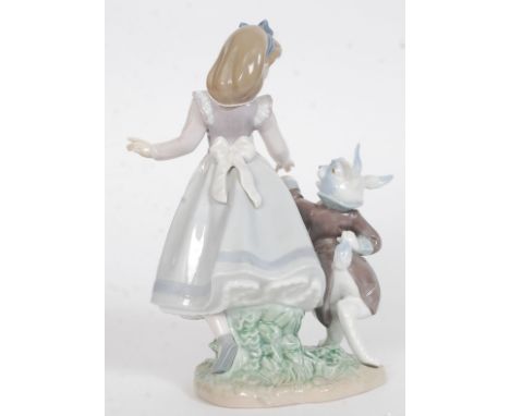 A Lladro figurine ' Alice in Wonderland ' Impressed factory marks 5740 to base also bearing  blue stamp to base. Measures 22.