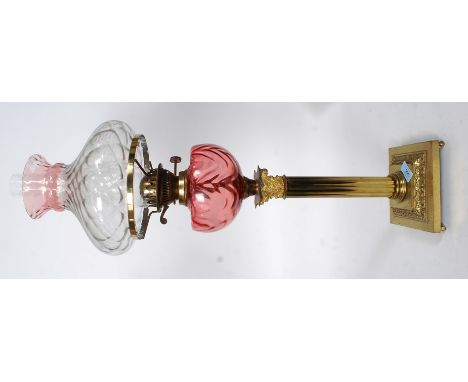 A  20th century  neo classical brass and cranberry glass reservoir oil lamp. Square terraced base with gilt brass Corinthian 