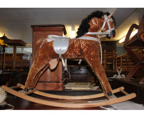 A vintage 20th century rocking horse raised on wooden sleigh runners with upholstered horse atop