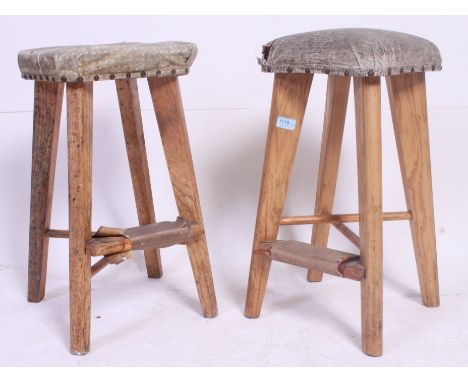 A near pair of vintage retro stools having studded seat pads, tapered legs. H60 x W33 x D33 cm 