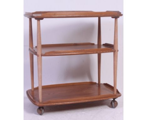 A 1970's Ercol blonde oak three tier tea trolley with galleried tiers raised on castors, height H75 x W72 x D46 cm 