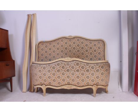 A 1930's French Louis XV style corbeille painted tapestry upholstered bow front double bed having show wood head and footboar