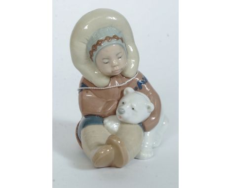 A Lladro figurine ' Eskimo Boy with Pet Polar Bear ' Bearing impressed model  No 1195 with blue stamp to base. Measures 12cms