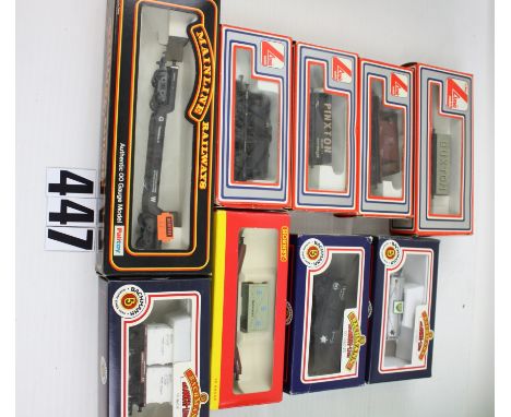 Boxed OO Gauge Freight stock by various makers: including Esso and BP tankers and BR conflat by Bachmann, four assorted wagon