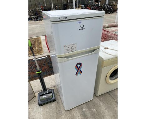 A WHITE INDESIT UPRIGHT FRIDGE FREEZER