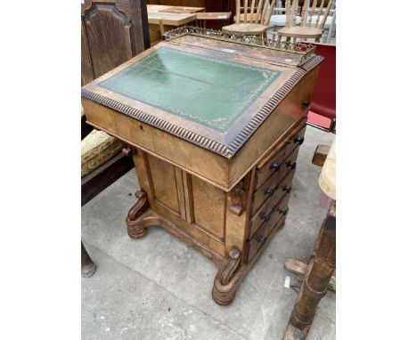 A VICTORIAN WALNUT DAVENPORT ENCLOSING EIGHT DRAWERS WITH BRASS GALLERY BACK