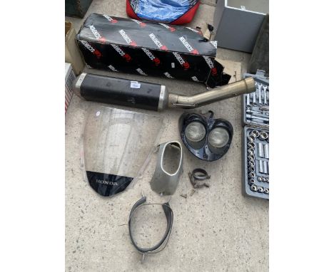 AN ASSORTMENT OF MOTORBIKE SPARES TO INCLUDE AN EXHAUST PIPE, LIGHTS AND BRAKETS ETC