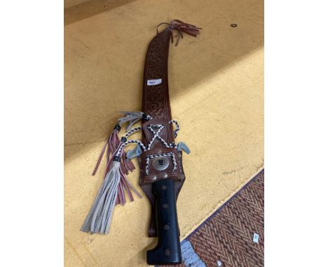 A LONG BRAZILIAN MACHETE IN AN ORNATE LEATHER SHEATH