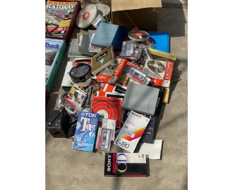 A PROJECTOR AND AN ASSORTMENT OF VARIOUS TAPES AND VHS VIDEOS ETC
