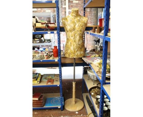 A SIX FOOT MANNEQUIN ON A WOOD AND METAL STAND