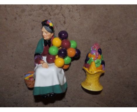 A Royal Doulton Old Balloon Seller 1315 and a Carlton fruit moulded sugar caster. (2)