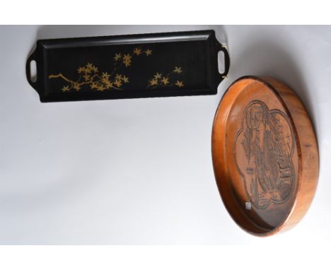 A Japanese wood tray of circular form, engraved with a five petalled panel depicting a palace, pagoda and Torii gate set in a