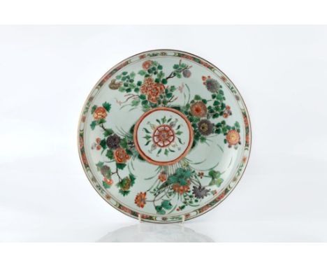 A Chinese famille verte shallow circular dish Kangxi having a central flower head and four sprays of flowers around the centr