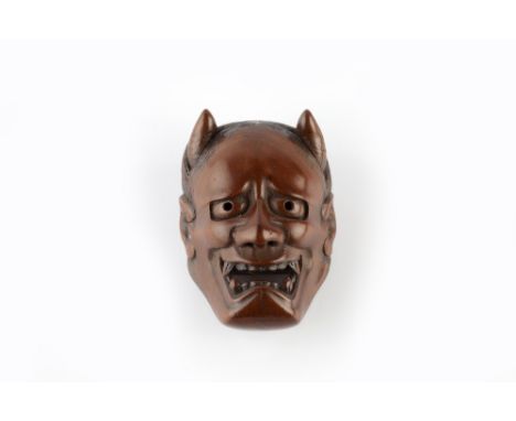 A wood Noh type netsuke mask representing Hannya early Meiji signed and with three characters and a seven character inscripti