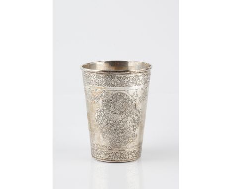 A Persian silver tapering beaker 19th Century engraved with a quatrefoil panel of an interior scene within foliate bands to t