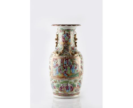 A Chinese Canton baluster vase 19th Century painted in enamels with an interior scene with raised dragon mounts, 46cm high