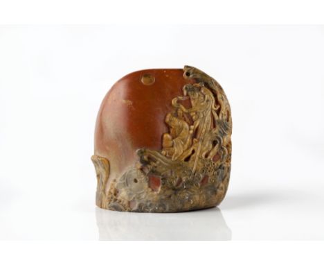 A Chinese orange brown soapstone seal 19th Century of irregular form carved to one side in relief in spinach green and cream 