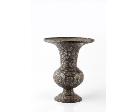 An Indian bidri flared vase 19th Century with raised silver metal fish and flower head designs with stepped circular base, 22