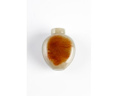 A Chinese jade snuff bottle late 19th Century with brown striated inclusions, 4.75cm high