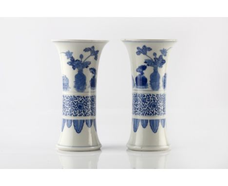 A pair of Chinese blue and white trumpet vases 19th Century having bands of vases of flowers, lotus and palmettes, Kangxi mar